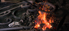 Ironworker Forging Hot Iron In Workshop