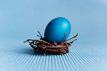 Blue Easter Egg In The Nest On Blue Background