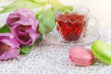 Wall Mural - cup of karkadeh red tea with macaroons and tulips