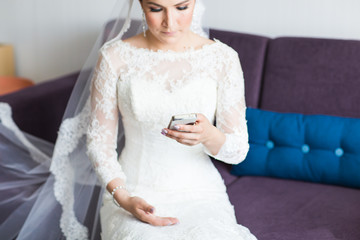 beautiful bride  with mobile phone. Concept of love and interest. Newlywed