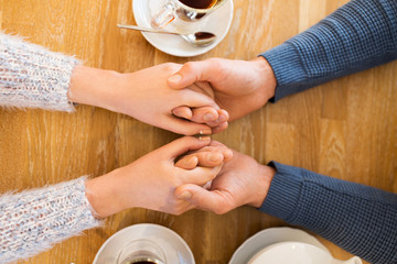 Sticker - close up of couple holding hands at restaurant