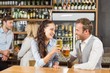 © WavebreakMediaMicro - Couples looking at each other while holding beer