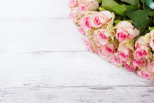Bouquet Of Pink Roses With Blue Ribbon For Present On A Vintage Wooden Background, Top View..