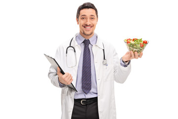 Wall Mural - Cheerful doctor holding a salad