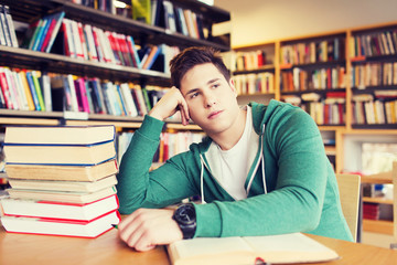 Wall Mural - bored student or young man with books in library