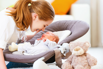 happy family. mother plays with newborn baby