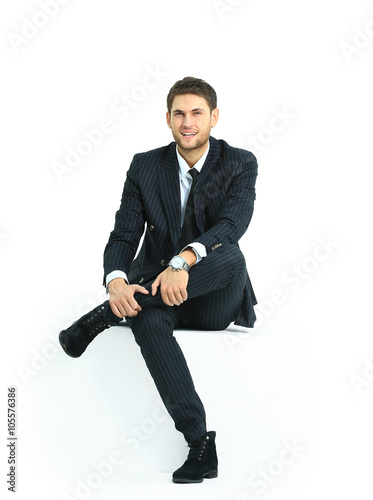 Fotografía handsome young business man sitting on a white modern chair