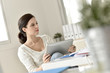 © goodluz - Businesswoman in office working on digital tablet