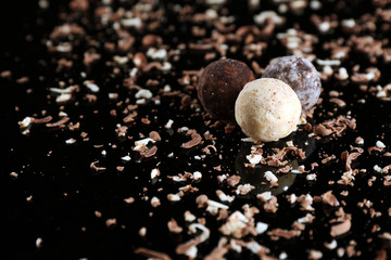 Sticker - Assorted chocolate candies with flakes on black background