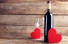 Red Hearts With Wine Bottle And Glasses On Wooden Background