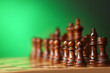 Leinwandbild Motiv Chess pieces and game board on green background