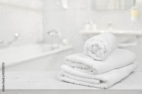 Fotografie, Obraz Stack of folded white spa towels over blurred bathroom background
