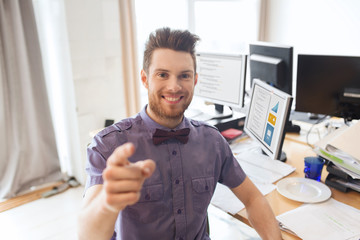 happy male office worker pointing finger at you
