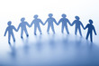 Paper people standing together hand in hand. Team, society, business concept