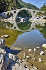 Reflection of The Devil's Bridge and Rhodopes mountain in Arda river, Kardzhali Region, Bulgaria 