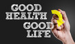 Hand writing the text: Good Health - Good Life