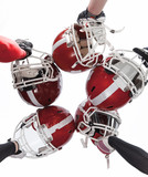 Fototapeta Sport - The hands of american football players with helmets on white background