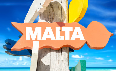 Wall Mural - Malta signpost with beach background