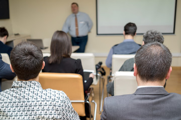 rear view of people participating in the business training.