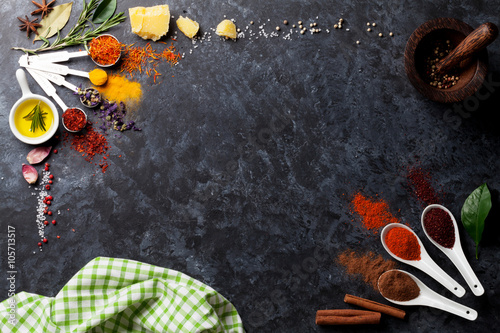 Fotografia Herbs and spices over black stone