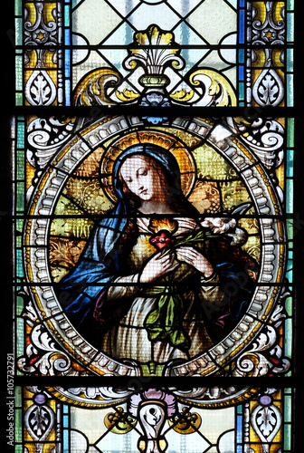 Fototapeta na wymiar Immaculate heart of Mary, stained glass window in Cathedral of St Nicholas in Novo Mesto, Slovenia 