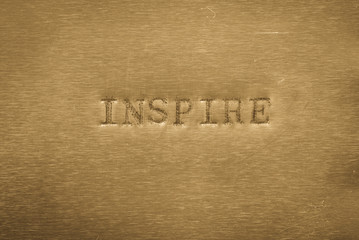 word inspire printed on metallic background