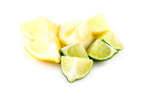 Fototapeta Kuchnia - Pieces of cut lemons and limes on white background