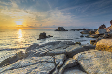 Wall Mural - Beach rock and wave with sunrise skies background