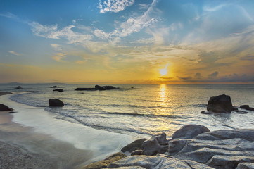 Wall Mural - Beach rock and wave with sunrise skies background