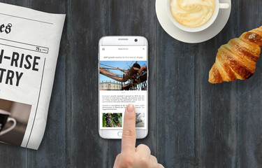 Poster - Reading news on the phone during breakfast. Newspapers, coffee, croissant on the table with top view.