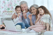© aletia2011 - senior couple with grandchildren  and laptop