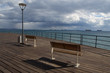 Wooden pier on the beach. Ships at sea. Limassol's seafront promenade. Cyprus.