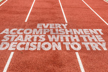 Every Accomplishment Starts With The Decision To Try Written On Running Track