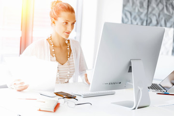 Wall Mural - Attractive office worker sitting at desk