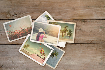 summer photo album on wood table. instant photo of polaroid camera - vintage and retro style