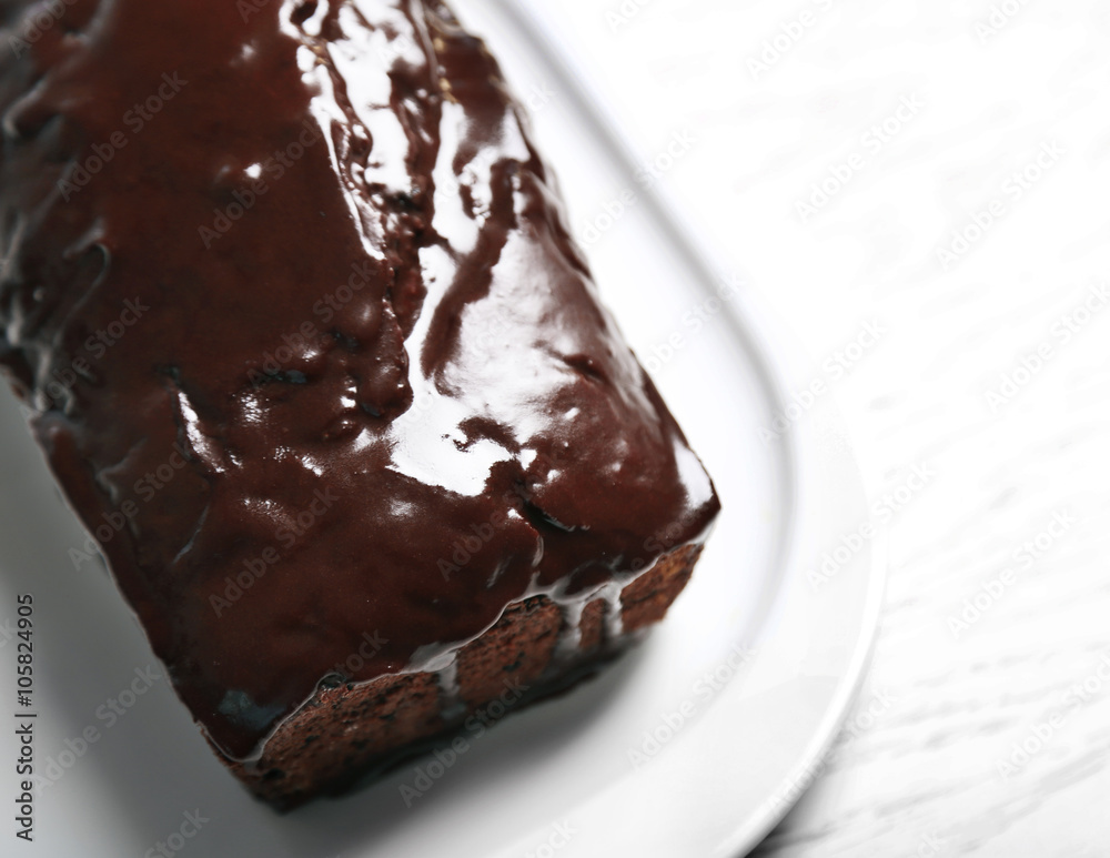 Chocolate cake with icing on white table