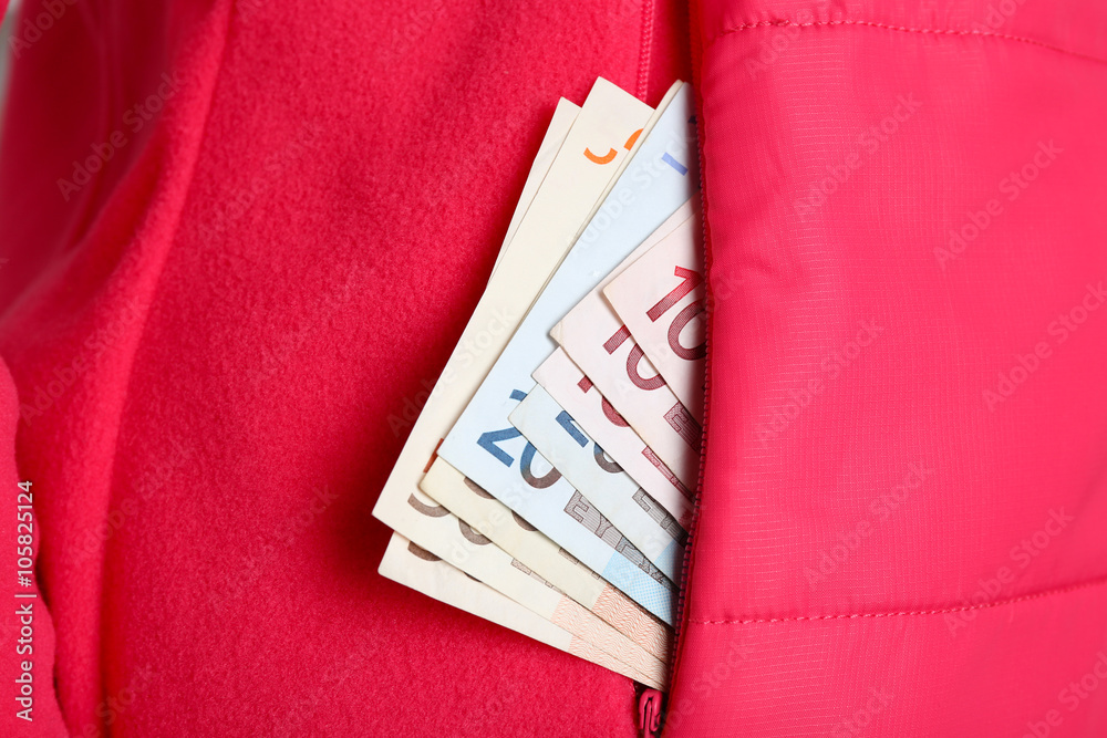 Cash in the red jacket pocket, close up