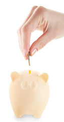 Poster - Female hand putting coin into piggy bank isolated on white