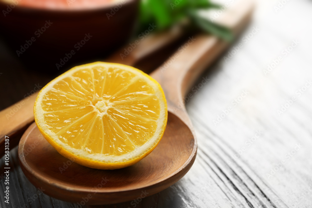 Piece of lemon on light wooden table