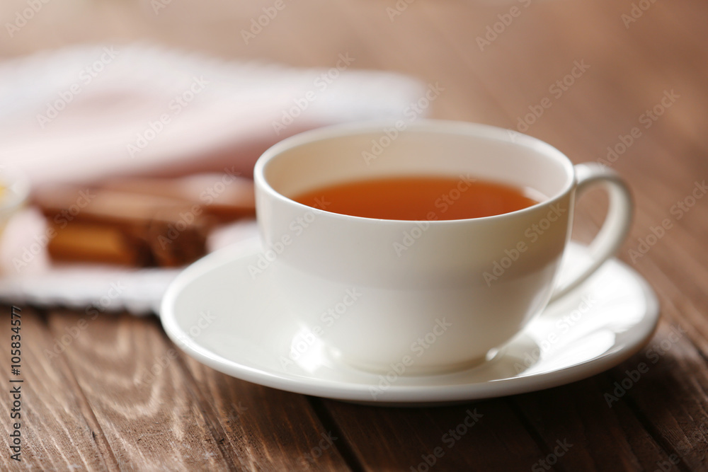 Cup of tea on wooden table closeup