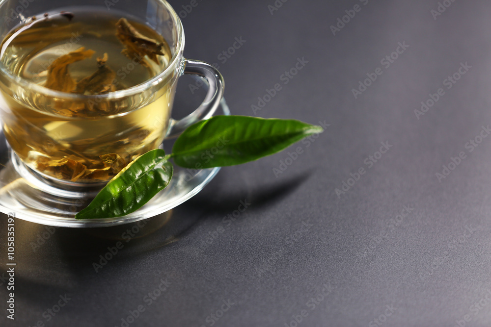Cup of green tea on dark background