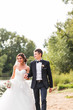 © satura_ - Wedding couple walking  near lake.