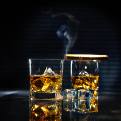 Whiskey with smoking cigar