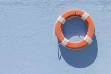 Red Lifebuoy Hanging On Wall
