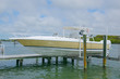 © Michael O'Keene - Expensive center console twin engine fishing boat on a lift at a dock
