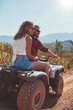 © Jacob Lund - Young couple enjoying a quad bike ride in countryside