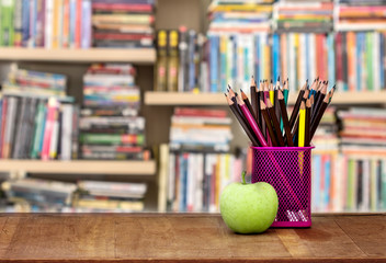 green apple with pencil box on wooden table in concept of study