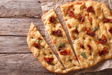 Canvas Print - Italian focaccia with sun-dried tomatoes. Horizontal top view
