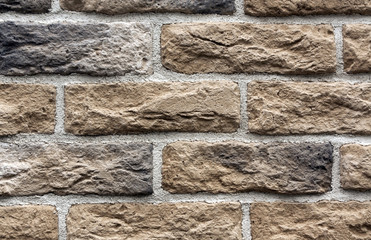 Beige and gray brick wall surface.