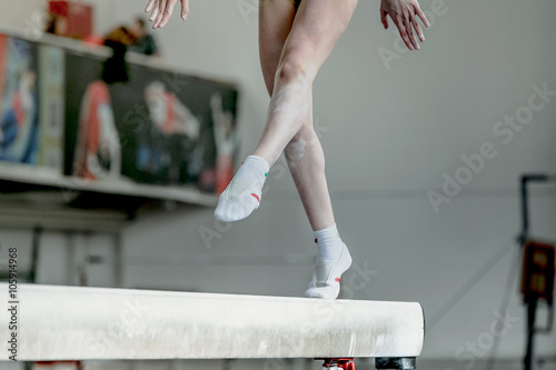 Plakat girl gymnast athlete during exercise on balance beam in gymnastics competitions